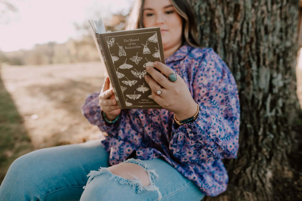 woman reading book under treet