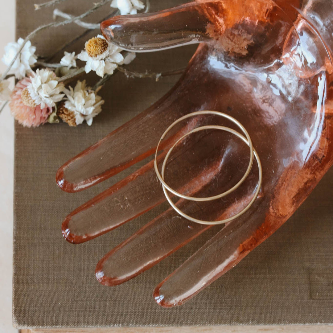 Decorative glass hand with a ring on an old book with flowers